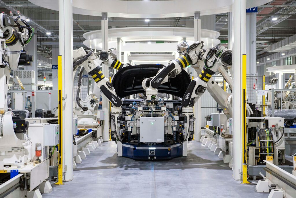 pexels-photo-19233057-19233057 High-tech robots assembling a car in a modern factory setting, showcasing automation.